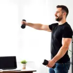 Young-man-doing-dumbbell-strength-training-at-home-to-build-muscle-and-prevent-early-muscle-loss