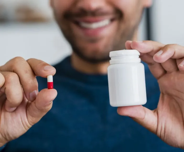 close-up-young-man-holding-pill-pill-recipient-(1)-(2)